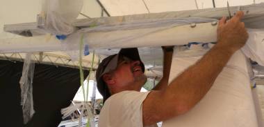 Jon wrestling with a horizontal davit bar, bolted to the targa-bar