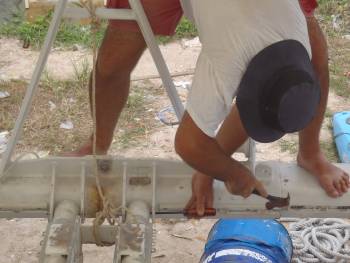 Removing the pins holding the anchor support beam