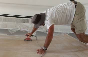 Jon trying to sand the middle of the underside of the bimini