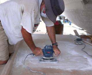 Sanding the bimini so the gelcoat will stick securely