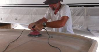 Jon sanding down the fiberglass layup from Friday