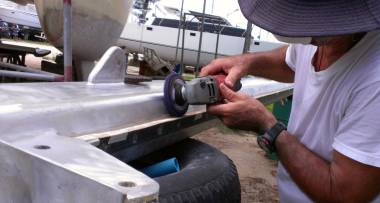 Using a strip of fiberglass to keep from damaging the sail-track