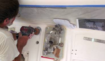 Jon sanding a flat for the reefing pad-eye next to the mast base