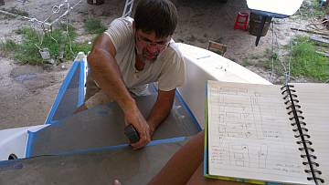 Jon measuring sugar-scoop dimensions while Sue records