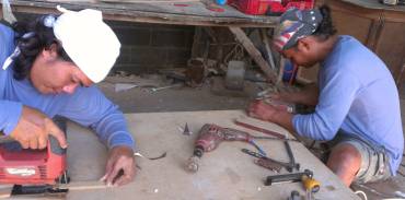 K and Houa making bits of teak trim in their workshop