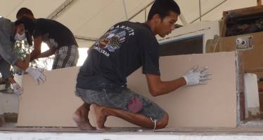 Max squooshing the foam into the glass & epoxy mud