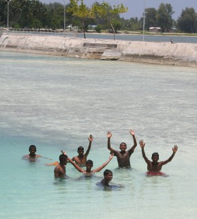 Lots of boys in the Maldives swim. Women sometimes come to the beach, fully dressed.