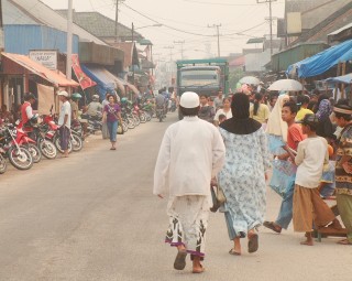 A smoky sky over the busy main street of Kumai, Kalimantan