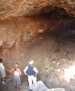 Rodrigo, Amanda, and Tony stand just inside a lava tube