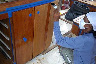 Lek brushes thinned epoxy on the galley peninsula