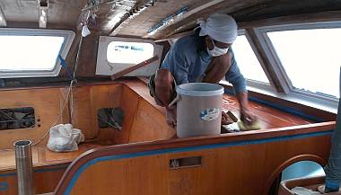 Lek sanding the big shelf on the starboard side of the salon