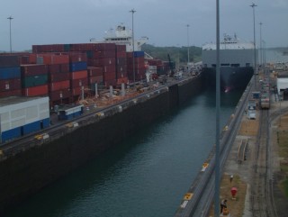 A container ship & a car-carrier going up Gatun Locks