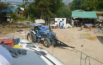 Manop's tractor maneuvers us away from our 2-year work site