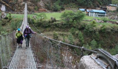 Sue and Pema cross the Dudh Kosi on a Swiss bridge