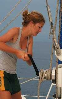 Rachel winching up the mainsail