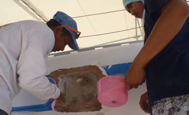 Goy & a helper filling a badly repaired misplaced porthole