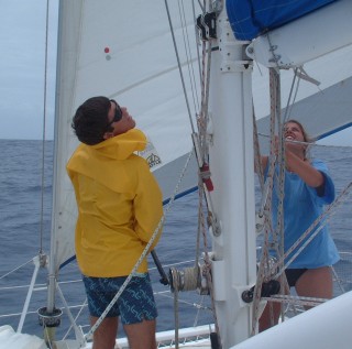 Chris and Amanda shake out a reef on a blustery sail to Savusavu.
