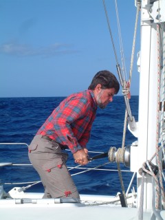Jon at the mast resetting the main after shaking out a reef