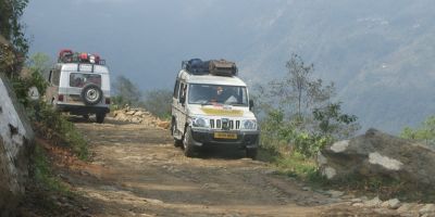 Share jeeps pass on a road in Sikkim