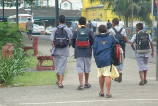 School boys wearing traditional sulus, just off the bus in Suva