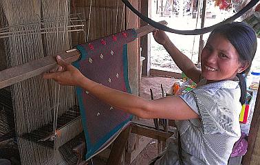 Tia Deng village woman showing off her weaving