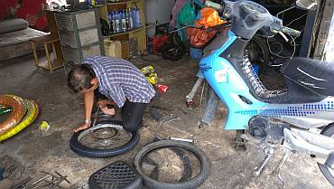 A Thai tire repair shop - his bed is in the upper left