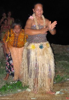 Tongan women dance and receive money "tips" from the audience