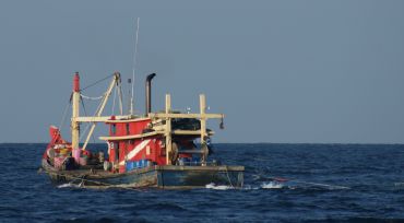 Fishing trawlers ply the Strait of Malacca, off Malaysia