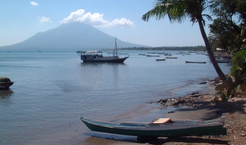 Typical village waterfront with volcano