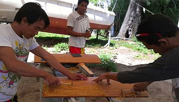 Scraping old varnish from the curved galley doors