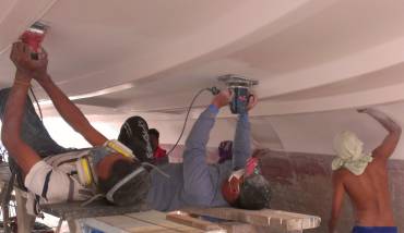 The tough work - sanding over their heads under the bridge-deck