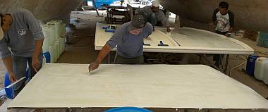 Spreading polyester glue on the nonskid and on the bimini